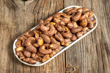 Shelled cashew on wooden background. Close-up of fresh cashews