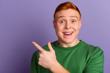 Photo of young cheerful man indicate finger empty space proposition select discount isolated over...