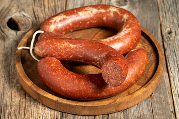 Sausage on a wooden background. Close-up spicy Turkish sausage