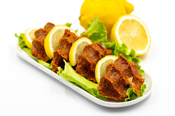raw meatballs or cigkofte on a white background. Close-up. local name cig kofte