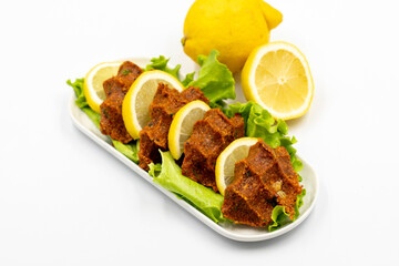 raw meatballs or cigkofte on a white background. Close-up. local name cig kofte