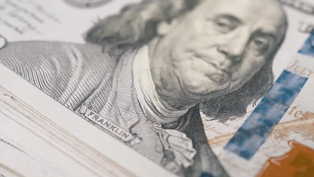100 dollar bills macro panning shot showing president franklin print