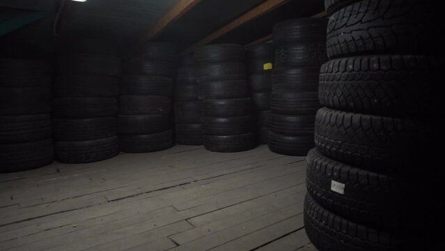 warehouse of used tires neatly stacked.
