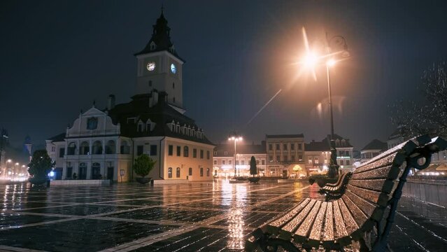 Timelapse view of The Council Square in Brasov at night, Romania. Old city centre, classic buildings, walking people, cars, nightlights