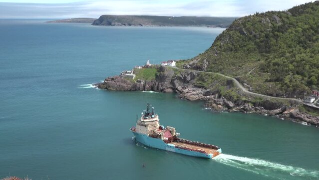 Canada. The ship passes by the lighthouse in St. John's. Province of Newfoundland and Lobrador. Newfoundland Lighting House. Vessel leaves port