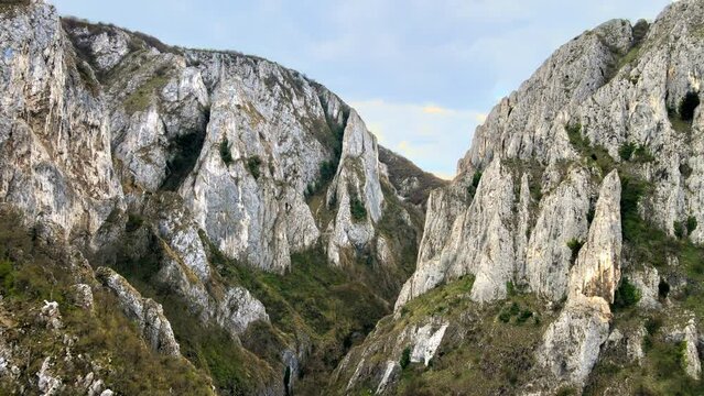 Aerial drone view of a rocky canyon in Romania. Rocky cliffs with sparce vegetation