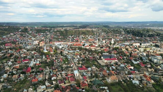 Aerial drone view of Cluj at sunset, Romania. Cityscape, district with old residential buildings, roads with cars