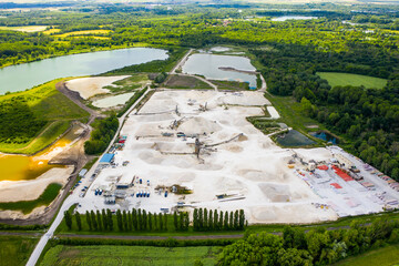 Aerial view of sandpit and factory plant producing sand materials for construction industry. Aerial view of the granite - gravel pit. Equipment for processing and crushing stones. 