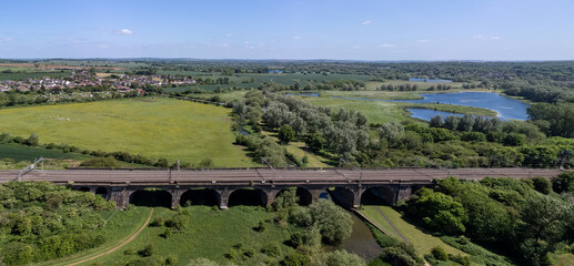 A high level aerial panorama view of the viaduct over the river Great Ouse at Wolverton, UK in summertime