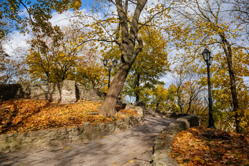 Fototapeta premium Riga, Latvia, 19 October 2021: Beautiful Bastejkalna Central Park with canals near the Latvian National Opera at autumn sunny day, bridge over water