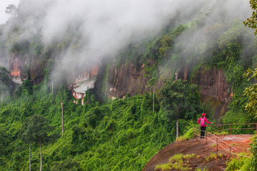 Young women hiking on Nakee Cliff, Phu Langka National Park, Nakon Phanom province,Thailand.