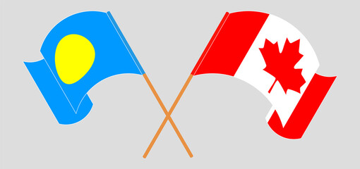 Crossed and waving flags of Palau and Canada