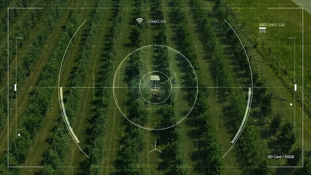 Drone Technology For Smart Agriculture - Orchard Spraying. Agricultural Drone With Smart Farming Application For Overall Spraying Control. Tractor Sprays Pesticides In An Orchard.