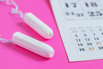 Woman hygiene protection, menstruation calendar and clean cotton tampons.