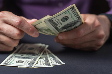 Close up male hand Counting money us dollar. Financial business concept.