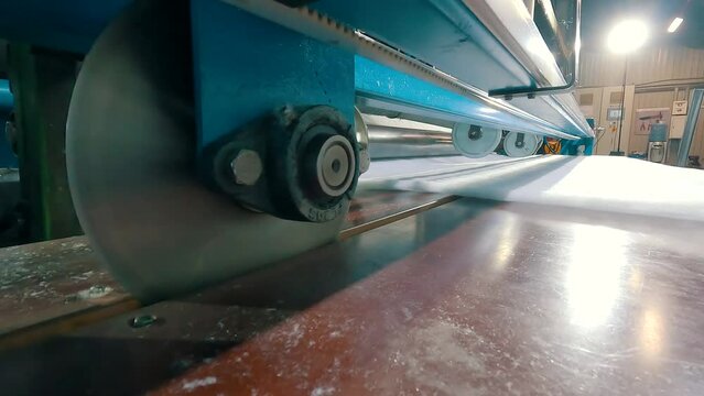 Synthetic winterizer on the conveyor line, close-up. Factory for the production of non-woven materials. Production of synthetic winterizer close-up. Syntepon manufacturing process