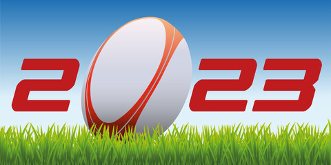L’année 2023 avec un ballon de rugby posé sur la pelouse d’un terrain pour symboliser le lancement de la nouvelle saison de compétition. - obrazy, fototapety, plakaty
