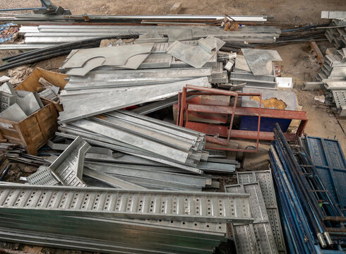 Group of the metal frame and equipment pile on the ground.