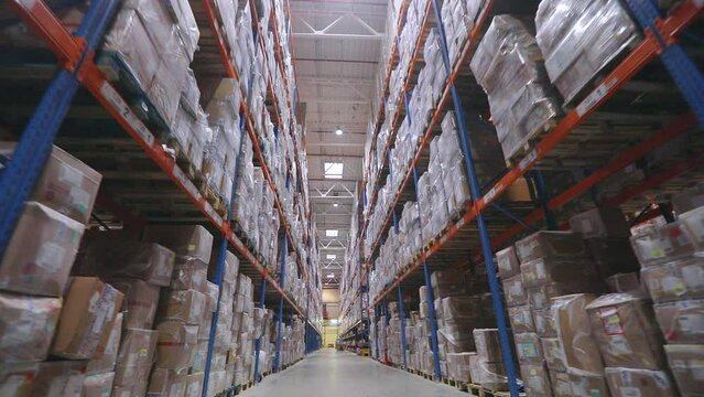 Large warehouse with goods. Very large warehouse with high shelves. Inside a large warehouse. Modern warehouse