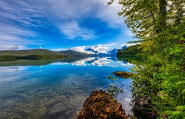 Lake McDonald in Glacier National Park with rock and sky reflection.