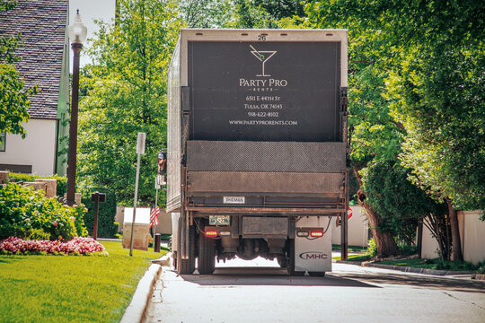 2022_05_27_Tulsa, OK USA - Large Party Pro Rents Truck Parked On Leafy Neighborhood Street For Resident Planning Event At Their Home.