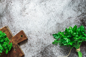 green fresh fragrant parsley lies on a wooden board on a gray background 2
