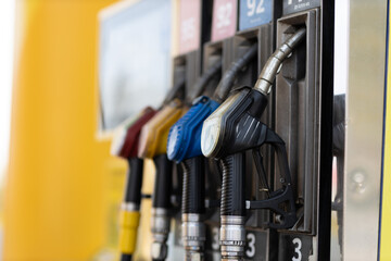 Close up filling gun in his hand at gas station. Sanctions economy crisis