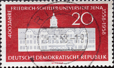 GERMANY, DDR - CIRCA 1958 : a postage stamp from GERMANY, DDR, showing the main building of the Friedrich Schiller University in Jena. 400 years Friedrich Schiller University Jena . Circa 1958