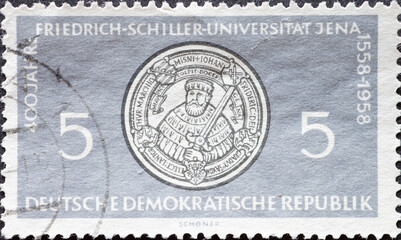 GERMANY, DDR - CIRCA 1958 : a postage stamp from GERMANY, DDR, showing the seal of the Friedrich Schiller University of Jena . 400 years Friedrich Schiller University Jena .Circa 1958