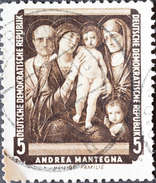 GERMANY, DDR - CIRCA 1957 a postage stamp from GERMANY, DDR, showing the "Holy Family with Saints Elisabeth and Joseph" by Andrea Mantegna . Circa 1957