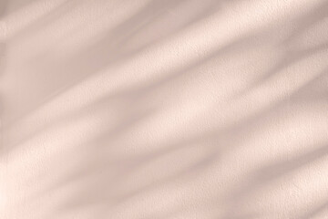 Leaf shadow and tree branch on wall. Nature leaves pastel beige, pink shadow and light from...