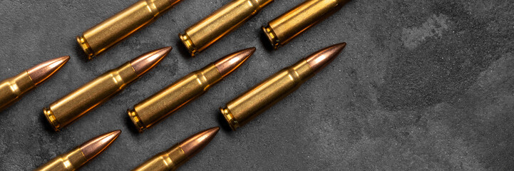 Bullets on gray background banner with copy space. Cartridges 7.62 caliber for Kalashnikov assault...