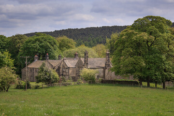 Fototapeta na wymiar A row of traditional stone farm cottages nestle in a Yorkshire valley of a peaceful village community