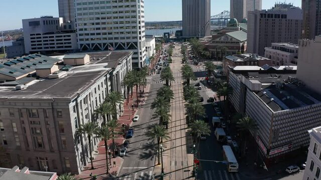 Aerial shot flying over Canal Street towards the Mississippi River in downtown New Orleans. 4K