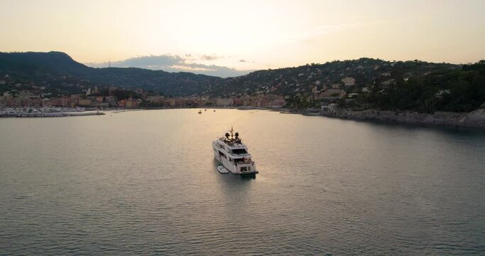 Luxury Yacht with Beautiful Sunset on Portofino Coast, Italy - Aerial Orbit