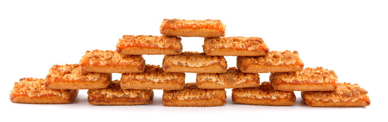 Orange cookies. Cookies with orange filling . The wall made of orange cookies is isolated on a white background .