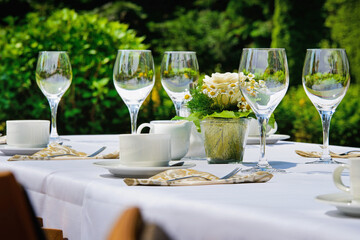 Restaurant or cafe in the garden. Laid table in nature.