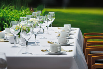 Table arrangement in nature. Covered restaurant table for an event in the green nature.