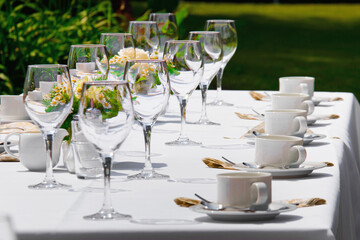 Table arrangement in nature. Covered restaurant table for an event in the green nature.