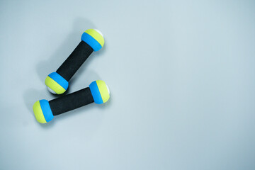 top view workout equipment with dumbbell on gray background