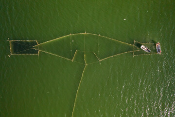 Aerial view to the Baltic sea with the fish traps and fishers. Drone photo.