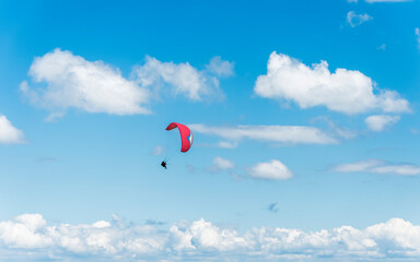 Fototapeta na wymiar A tandem paraglider flight against a beautiful blue sky. Top view of the embers in the Beskid Mały. A popular place in Silesia. Bielsko Biała, Poland