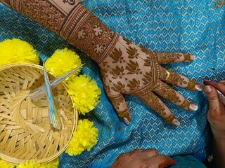 Mehndi artist making mehndi bridal hand In India, mehndi design.