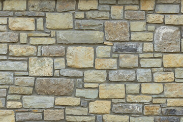 Solid yellow and beige stone wall. Stone background.