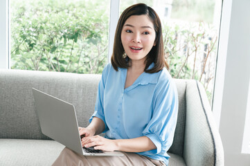 Adult Asia beautiful woman excited with computer notebook at home