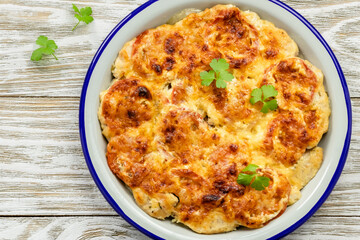 Healthy chicken vegetable loaded casserole on wooden background. Top view, copy space, flat lay.