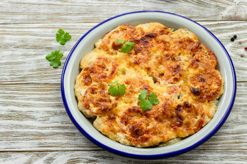 Vegetarian breakfast casserole on wooden background. Top view, copy space, flat lay.