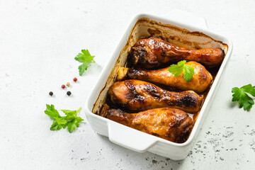 Sweet spicy garlic ginger chicken drumsticks in baking dish. Copy space.