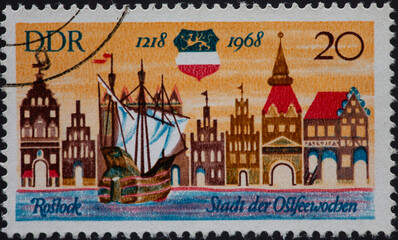 GERMANY, DDR - CIRCA 1968 : a postage stamp from GERMANY, DDR, showing the historic city view and coat of arms of Rostock. 750 years of Rostock around 1968