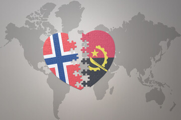 puzzle heart with the national flag of norway and angola on a world map background. Concept.
